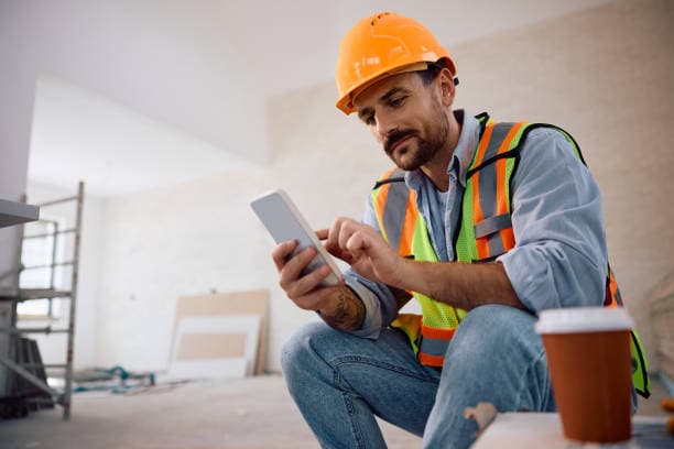 Independent contractor using a smartphone while working on site